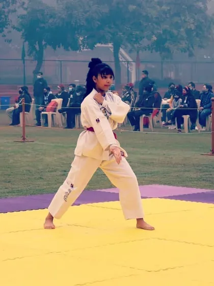A student performing her individual pattern (Tul) at a state competition. The judges look for balance, power, and correct form, all of which we drill relentlessly in our dojo.