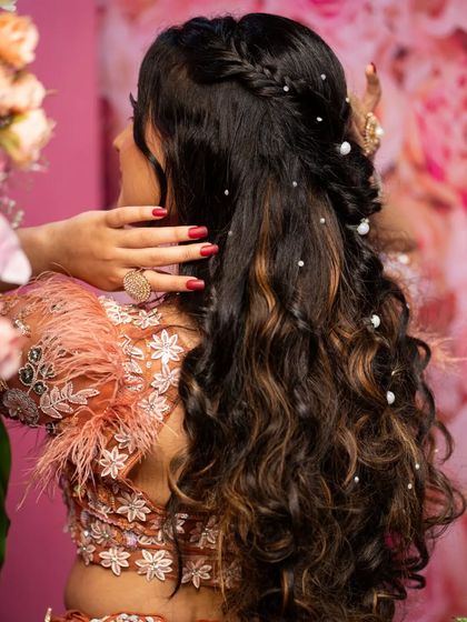 A detailed shot focusing on the bride's beautiful hairstyle, adorned with pearls. Capturing these small details is part of telling the complete story.