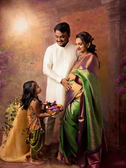 A growing family captured in a timeless, painterly style. The daughter offers a tray of flowers, adding a sweet, interactive element to this traditional family portrait.