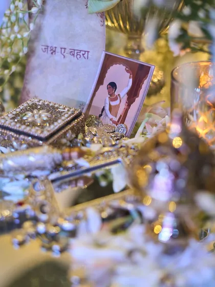 A 'Jashn-e-Bahara' card placed among the opulent table decor, reinforcing the poetic theme of the evening.