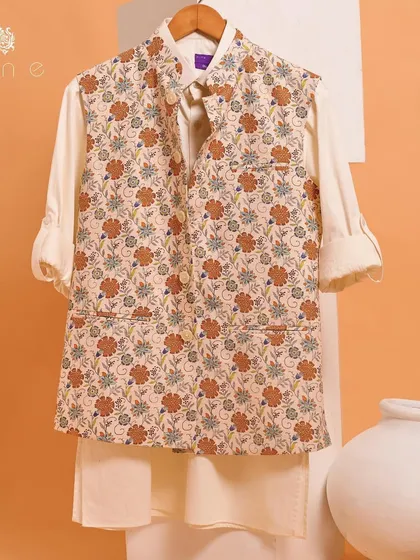 A beautiful floral jacket paired with a simple white kurta. This ensemble is perfect for a summer wedding or a garden party, offering a vibrant and stylish look.