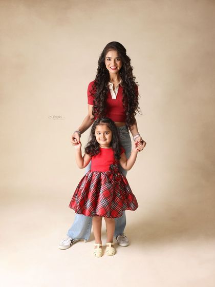 You and I in this beautiful world. A mother and daughter, coordinated in red, standing together for a portrait that is both stylish and sweet.