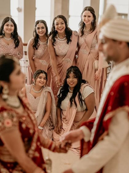 The bride and her bridesmaids posing for a group photo, a cherished memory of her support system on the big day.