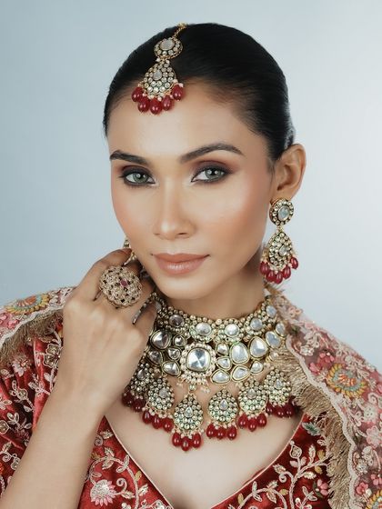 This pose highlights the maang tikka and intricate jewelry. You will learn how to apply makeup that complements and enhances these traditional bridal accessories.
