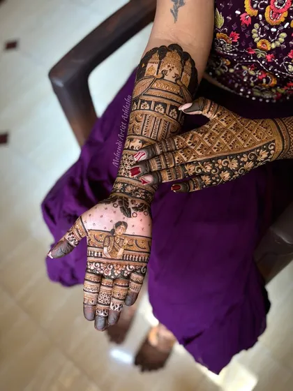 This bridal mehendi features a portrait of the bride on one palm and extends into a full-arm design with traditional motifs. It's a beautiful way to personalize your wedding henna.