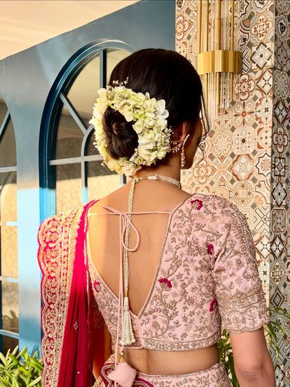A view of the beautiful floral bun, a classic choice that adds a touch of timeless elegance to any bridal look.