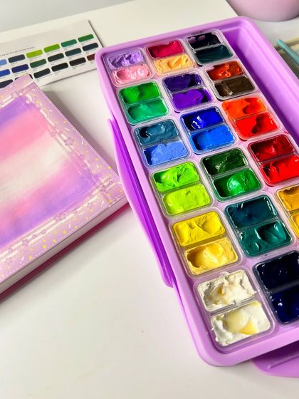 The setup for my butterfly painting, showing the Himi gouache palette and the initial background blend.