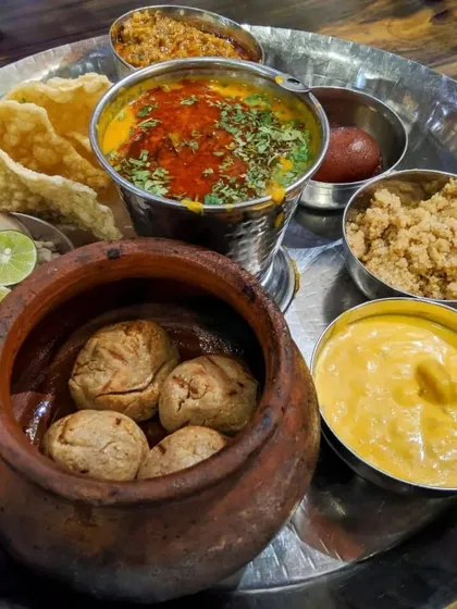 My passion is cooking authentic regional dishes. This is a traditional Rajasthani thali featuring Dal Baati Churma, prepared with classic recipes to bring the true flavors of India to your celebration.