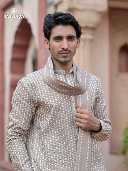 A close-up of the beige printed kurta, highlighting the subtle pattern and the soft fabric. The matching stole adds a touch of sophistication to this comfortable and stylish outfit.
