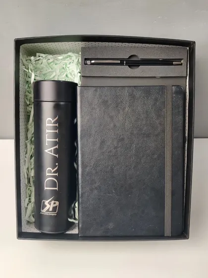 Here is an example of a sleek corporate gift set. This all-black essentials hamper includes a temperature-display bottle, a diary, and a metal pen, all customized with a name and company logo for a professional touch.