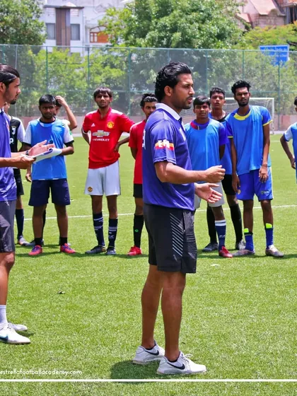 I am briefing a group of aspiring players during the selection trials for the Spain camp. Clear communication and professional guidance are key parts of my coaching philosophy.