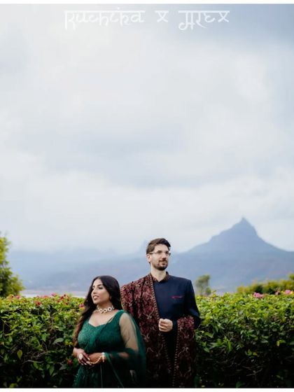 A stunning portrait of Ruchika and Alex. The majestic mountain backdrop in Lonavala provides a breathtaking setting for this simple yet powerful image, showcasing their connection.