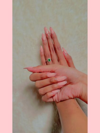 Another view of the long, almond-shaped pastel pink nails.