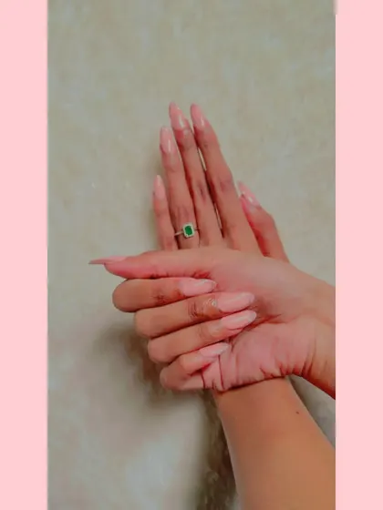 Another view of the long, almond-shaped pastel pink nails.