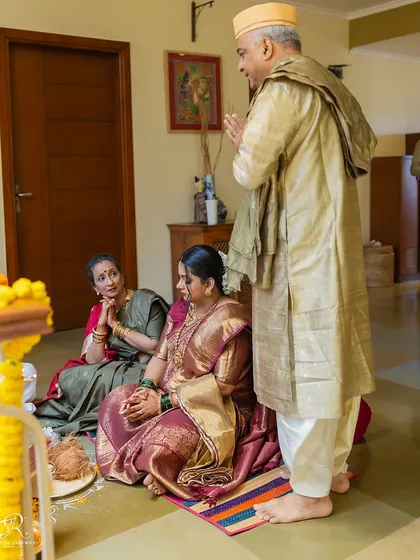 A candid moment during the puja at a home wedding, showing the reverence and emotion of the ceremony.