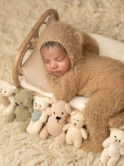 Our smiling Simba, surrounded by his teddy bear friends. This setup is perfect for creating a cute and playful newborn portrait.