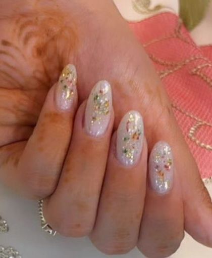 A delicate and shimmery set with a sheer white base and scattered flecks of colorful, dried-flower confetti.