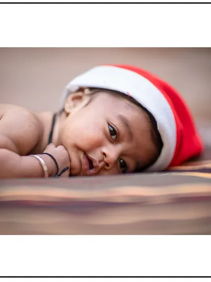 Getting into the festive spirit with a themed newborn shoot. This simple Santa hat adds a touch of seasonal fun to this baby's first Christmas portraits.