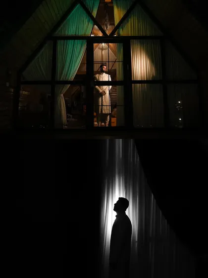 A powerful and creative composition of the groom, using reflection and silhouette to create a visually stunning image.