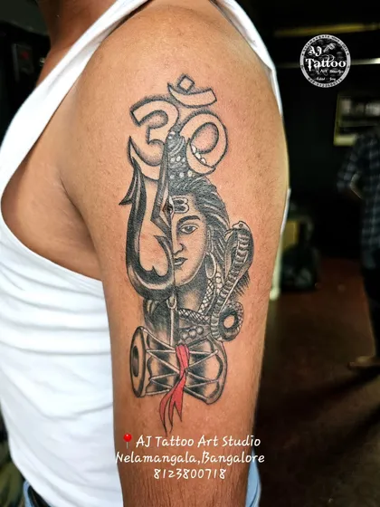 This powerful half-sleeve piece combines a portrait of Lord Shiva with his Trishul and Damaru. It's a complex design that shows my skill in creating detailed spiritual and mythological tattoos.