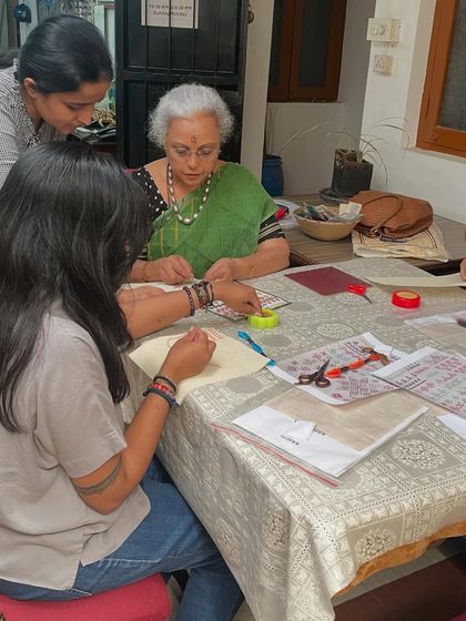 Guiding a student during a Kasuti workshop. I provide step-by-step help to ensure everyone feels confident and enjoys the process of learning.