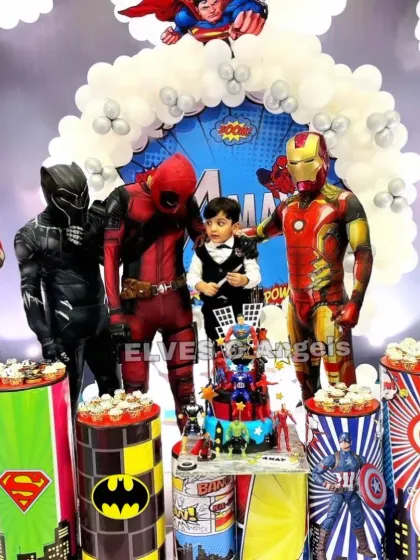 Assembling the ultimate superhero party! This event featured live character mascots including Spider-Man, Deadpool, and Iron Man, posing with the birthday boy for an unforgettable experience. The decor included themed cupcake stands and a full superhero backdrop.
