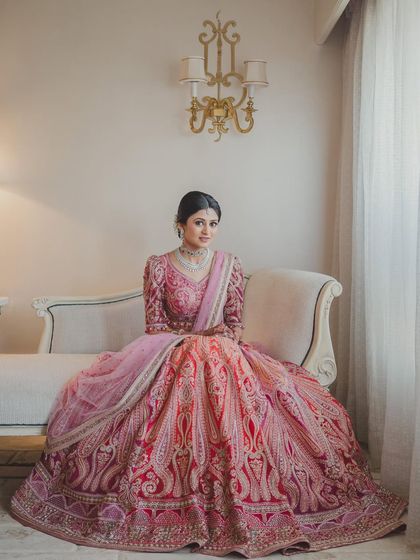 A spellbinding portrait of a bride in her fairytale Tarun Tahiliani lehenga. The makeup is soft and romantic, with pink shimmery eyes and a radiant complexion.