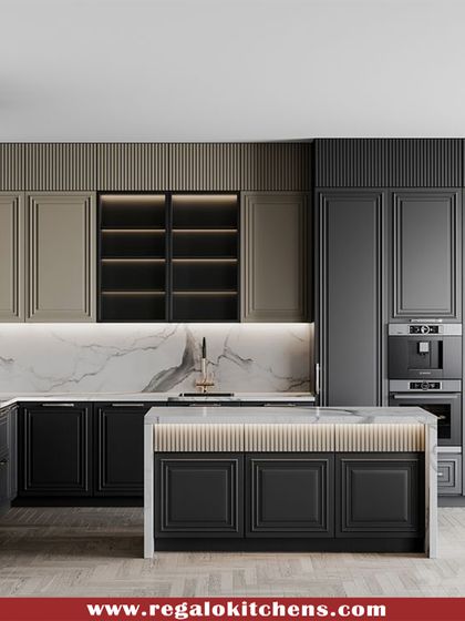 A bold and luxurious kitchen featuring black and beige shaker cabinets. The design includes a fully integrated fridge and double ovens, creating a seamless wall of functionality. The marble backsplash and under-cabinet lighting add to the high-end feel.