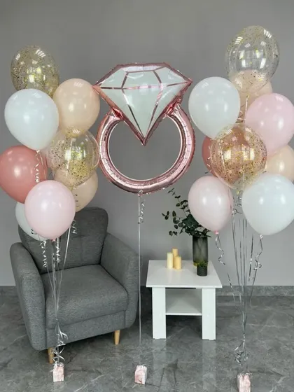 A chic and simple 'Bride to Be' decor setup with a diamond ring foil balloon and pastel-colored balloons, perfect for a modern bridal shower.