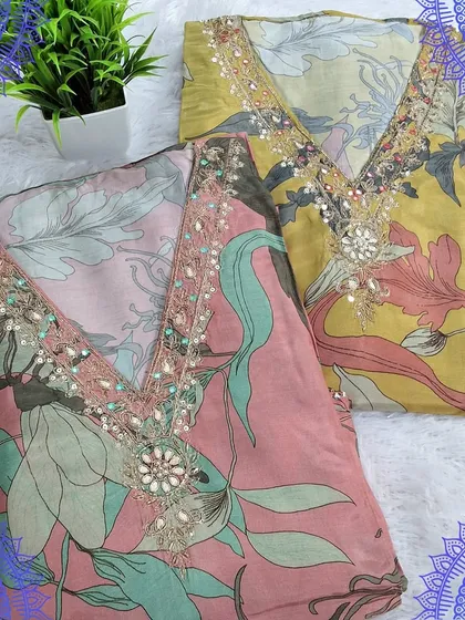 A set of two beautiful dress materials with digital floral prints and hand-embroidered necklines. The soft pastel colors make them perfect for any daytime function.