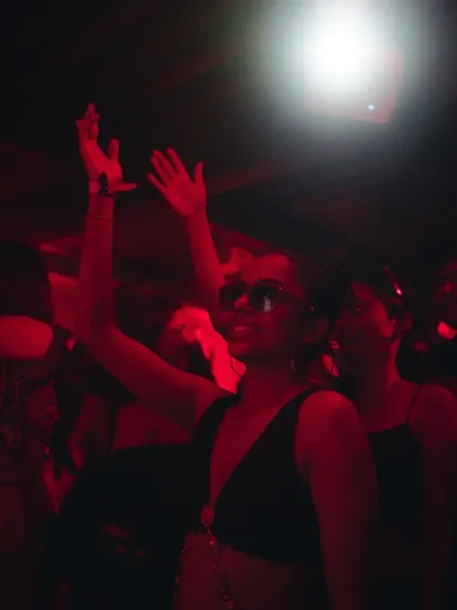 The crowd's reaction says it all. A dancer lost in the music under the red glow, capturing the essence of a great night at The Burrow.