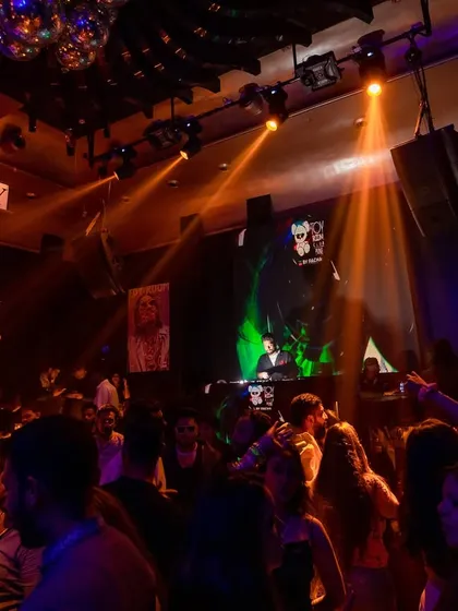 The club atmosphere under warm lighting. I adapt my set and visuals to match the mood of any venue, from intense raves to more intimate parties.