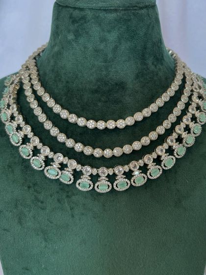 A three-layered American diamond necklace with mint green stones. This rental set is perfect for a daytime event.
