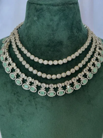 A three-layered American diamond necklace with mint green stones. This rental set is perfect for a daytime event.