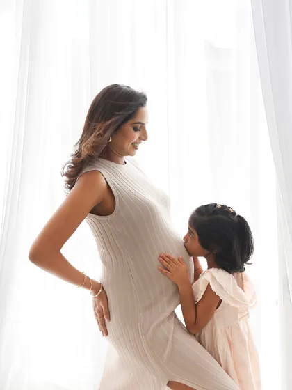 Welcoming a new baby is a family affair. There is nothing more precious than capturing the bond between a mother and child as they wait for the new arrival. This simple kiss on the belly is a memory they will all cherish.