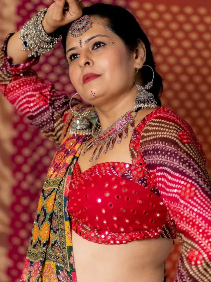 For festive events like Navratri, I love creating vibrant, detailed looks. I designed this entire dandiya outfit, from the mirror-work blouse to the multi-colored lehenga, complete with traditional silver accessories.