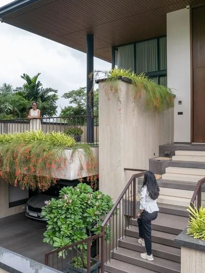The entrance sequence involves a journey up a staircase that winds through the terraced planters, making the arrival an experience in itself.