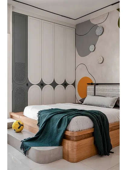 This kids' room blends playful charm with long-lasting function. A custom platform bed with built-in storage sits beside a concrete-finished step for play. The hand-painted abstract mural adds a splash of color, while arched details on the wardrobe and terrazzo accents create a space that is fun, earthy, and can evolve as the child grows.