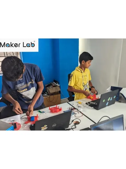 Collaboration is key. Two students work together on their project, sharing ideas and solving problems. Our labs encourage teamwork, a crucial skill for future engineers and innovators.