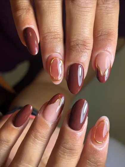 A full view of the sophisticated brown and gold abstract nail art.
