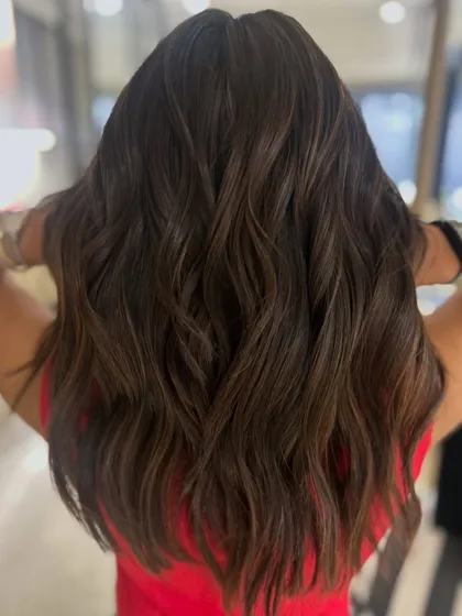 This three-tone classic highlight blend adds so much richness and dimension. I finished with a long layered haircut and styled with waves to make the colors dance.