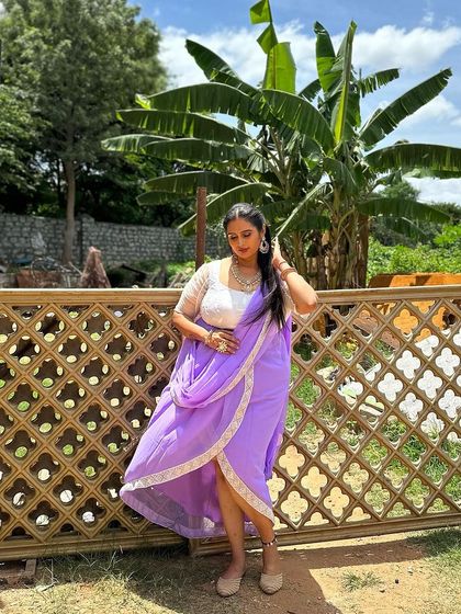 The full look of the lavender Indo-Western outfit designed for a film shoot. The high-low draped skirt adds a modern twist to the traditional half saree silhouette, making it perfect for a peppy dance number.