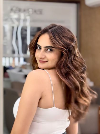 Another angle of this gorgeous caramel balayage, showing how the color catches the light to create dimension and a warm glow.