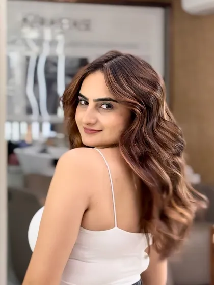 Another angle of this gorgeous caramel balayage, showing how the color catches the light to create dimension and a warm glow.