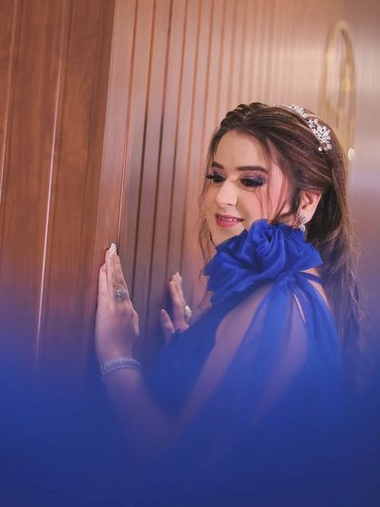 A creative take on the portrait, shot through a blue filter or fabric. This adds a dreamy, ethereal quality to the image while still highlighting the bride's elegant pose.