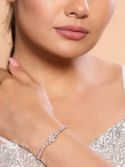 A close-up on a model's hand, displaying a delicate rose-gold bracelet. This detailed shot is perfect for e-commerce sites where customers want to see the product up close.