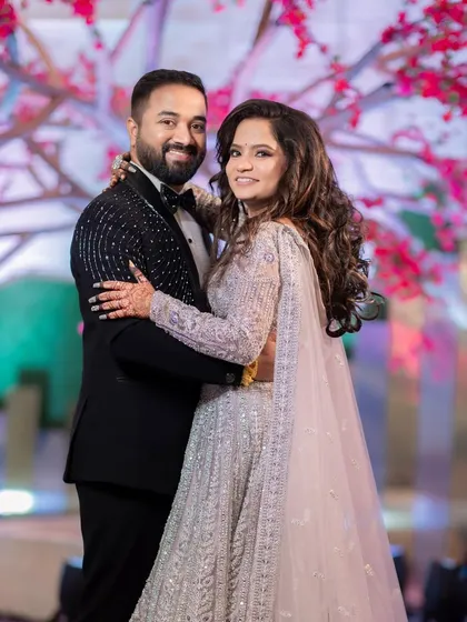 A grand reception look for a beautiful bride. The intricate silver lehenga is paired with soft, glamorous makeup and voluminous curls for a show-stopping effect.
