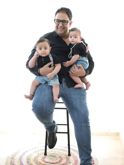 A proud father with his two handsome twin boys. This simple, classic portrait on a white background puts all the focus on the beautiful bond between a dad and his sons.