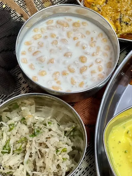 A side of refreshing Boondi Raita and Mooli Lachha, perfect accompaniments to a spicy Indian meal.