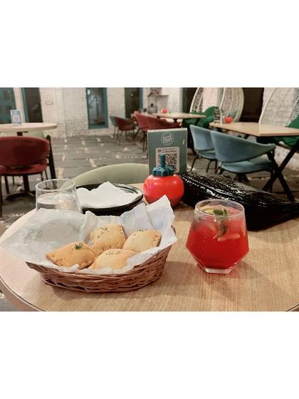 A snapshot of a relaxing afternoon at our cafe. A guest enjoys some snacks and a refreshing drink while soaking in the peaceful, dog-friendly atmosphere.